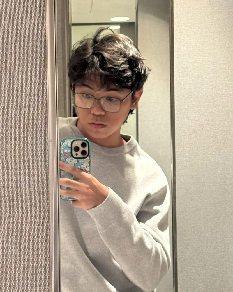 Paul Osio taking a mirror selfie in a lift