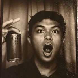 Paul Osio, pulling a surprised face in a photo booth